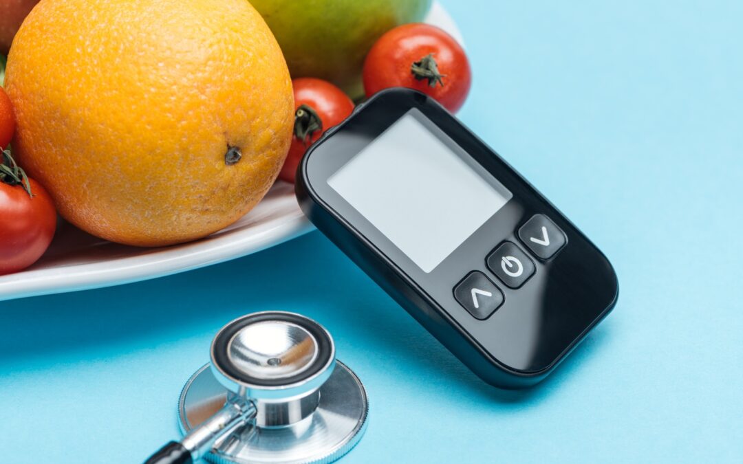 blood sugar monitor with fruit on table