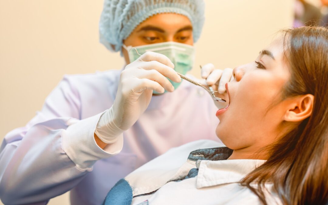 Dentist examining patients teeth